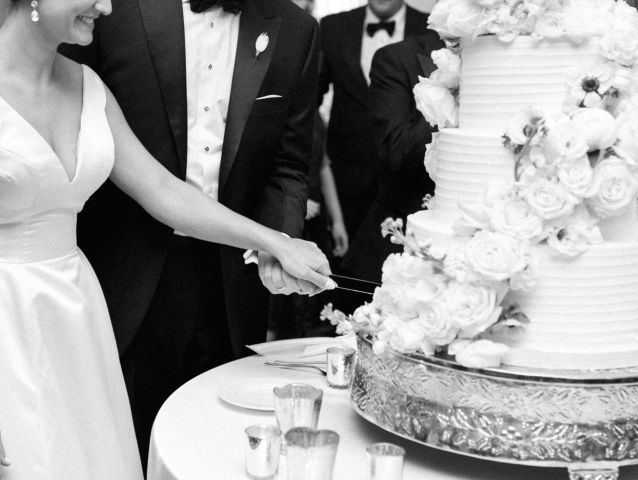 A Bride And Groom Cutting A Cake