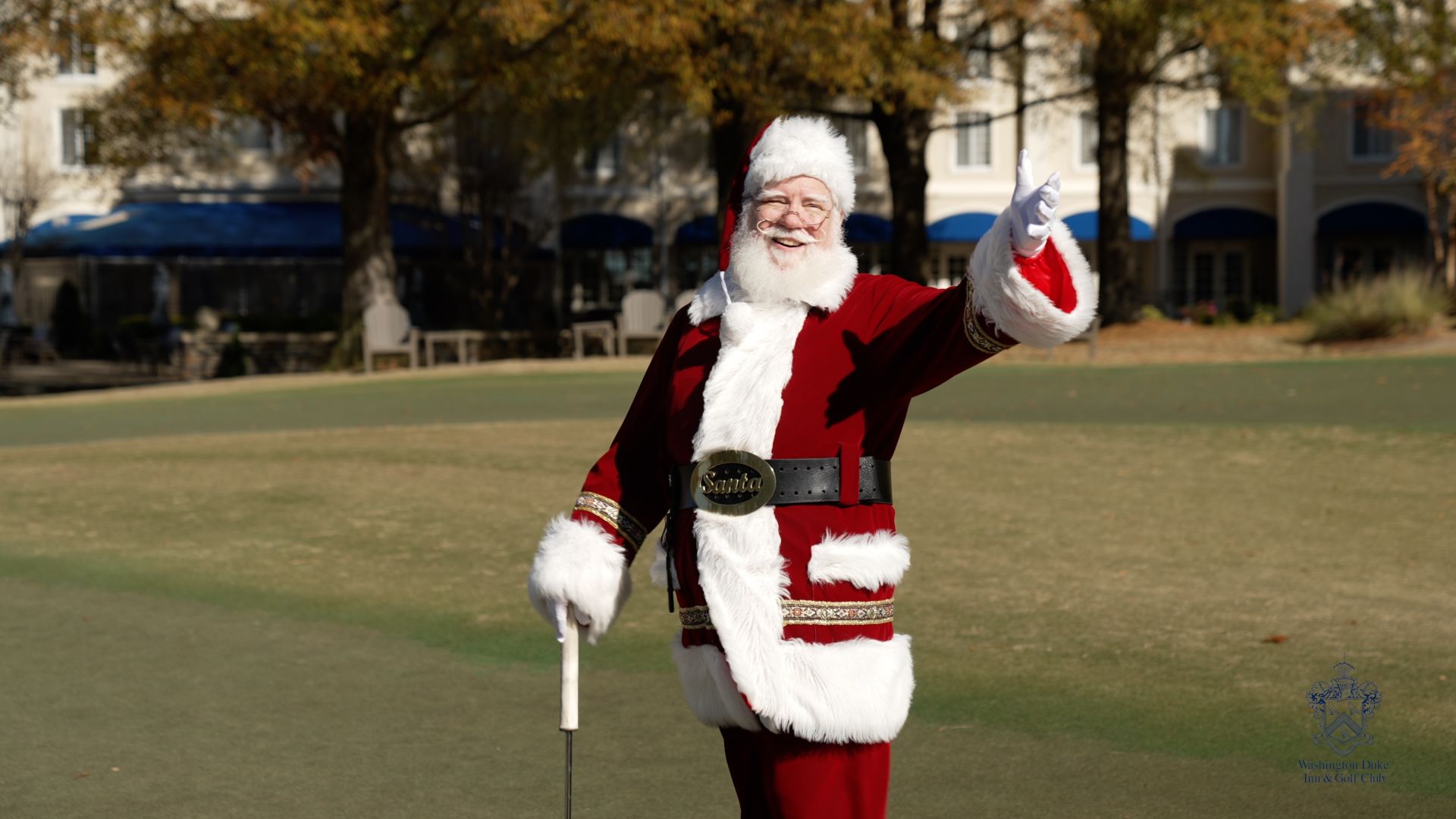 A Person In A Red And White Garment Holding A Golf Club