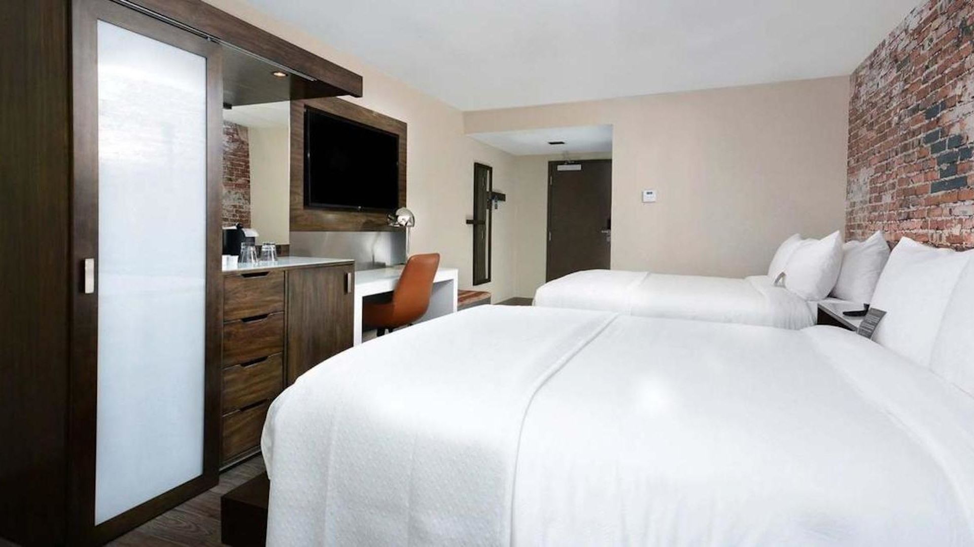 A Hotel Room With A Bed And A Tv